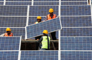 Workers install solar panels. 