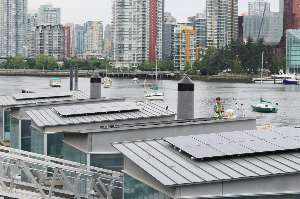 Duncan Martin of Vancouver Renewable Energy installing Creekside solar panels for Solar Now.