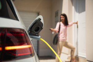 woman charging an EV at home