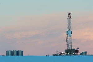 A natural gas drilling rig set in snowy field in British Columbia