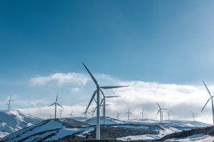 image of windmills over snowy hills