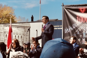 conservative party leader pierre poilievre speaking to a crowd holding a microphone