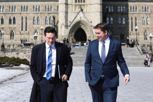 former conservative party leader andrew sheer walking next to pierre poilievre, chatting