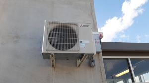 image of heat pump installed at side of building