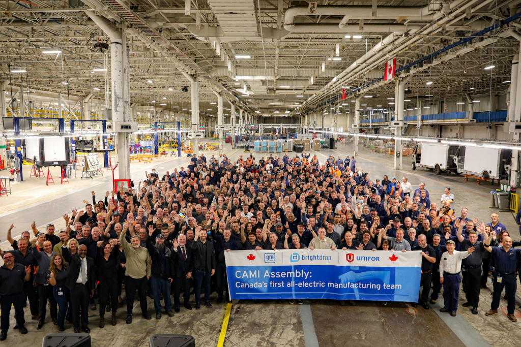 crowd of General Motors workers posing for the opening of Canada's first all-electric manufacturing plant in Ingersoll, Ontario.