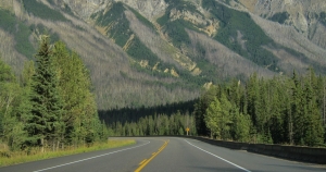 image of road towards a backdrop of mountains in golden, b.c.