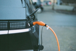 electric car plugged into charger on street